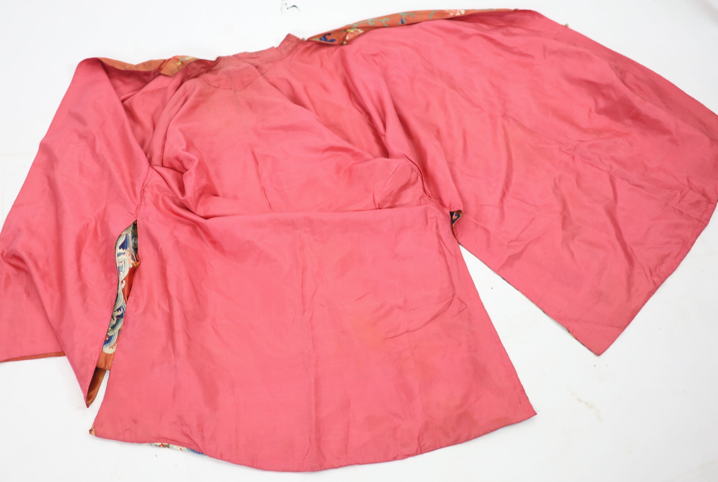 A Chinese apricot silk robe, mid 19th century, 125 cm long, wear to back of collar